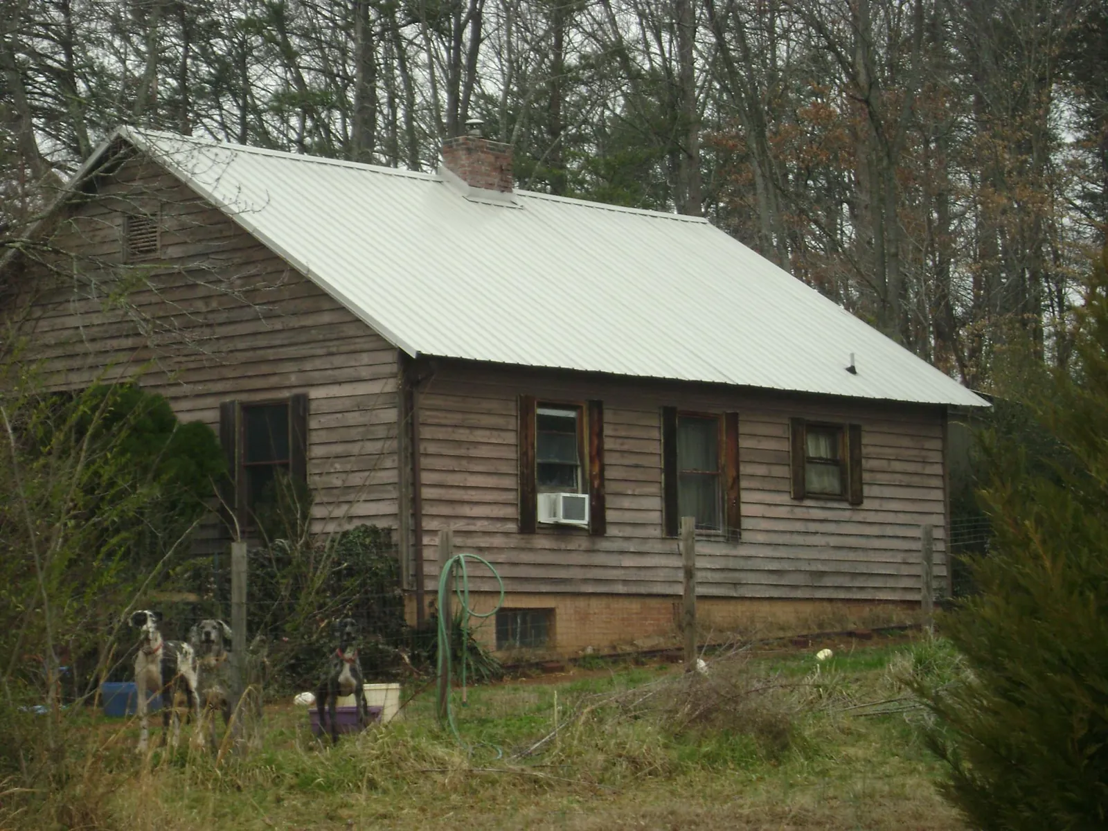 White metal roof on an old wood sided farmhouse, from a Metal Roof Installation job in Peru